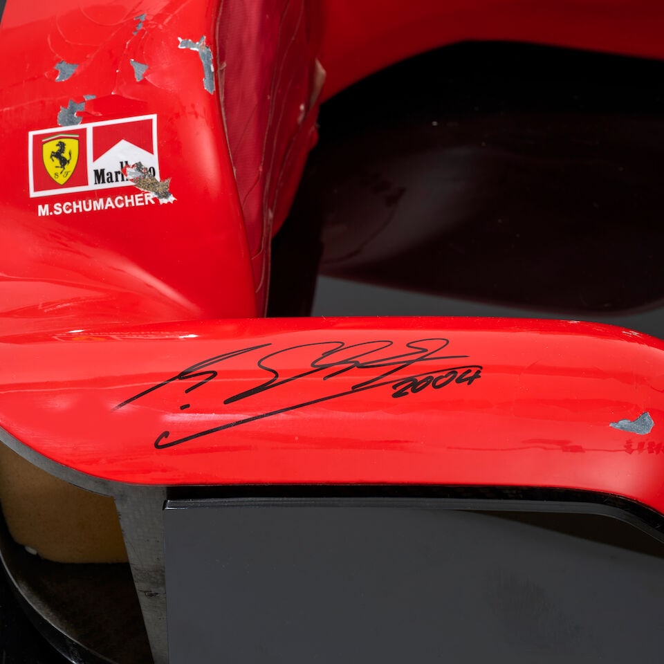 A Scuderia Ferrari F2004 F1 headrest signed by Michael Schumacher, - 4