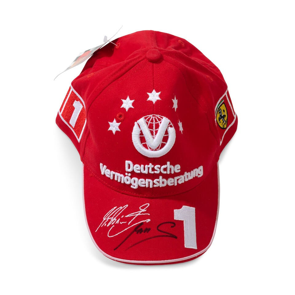 A Scuderia Ferrari Michael Schumacher 2003 cap signed by Mick Schumacher,: A Scuderia Ferrari Michael Schumacher 2003 cap signed by Mick Schumacher, believed size junior, with sponsors logos, signed to the peak in black marker by Mick Schumacher. For further information on