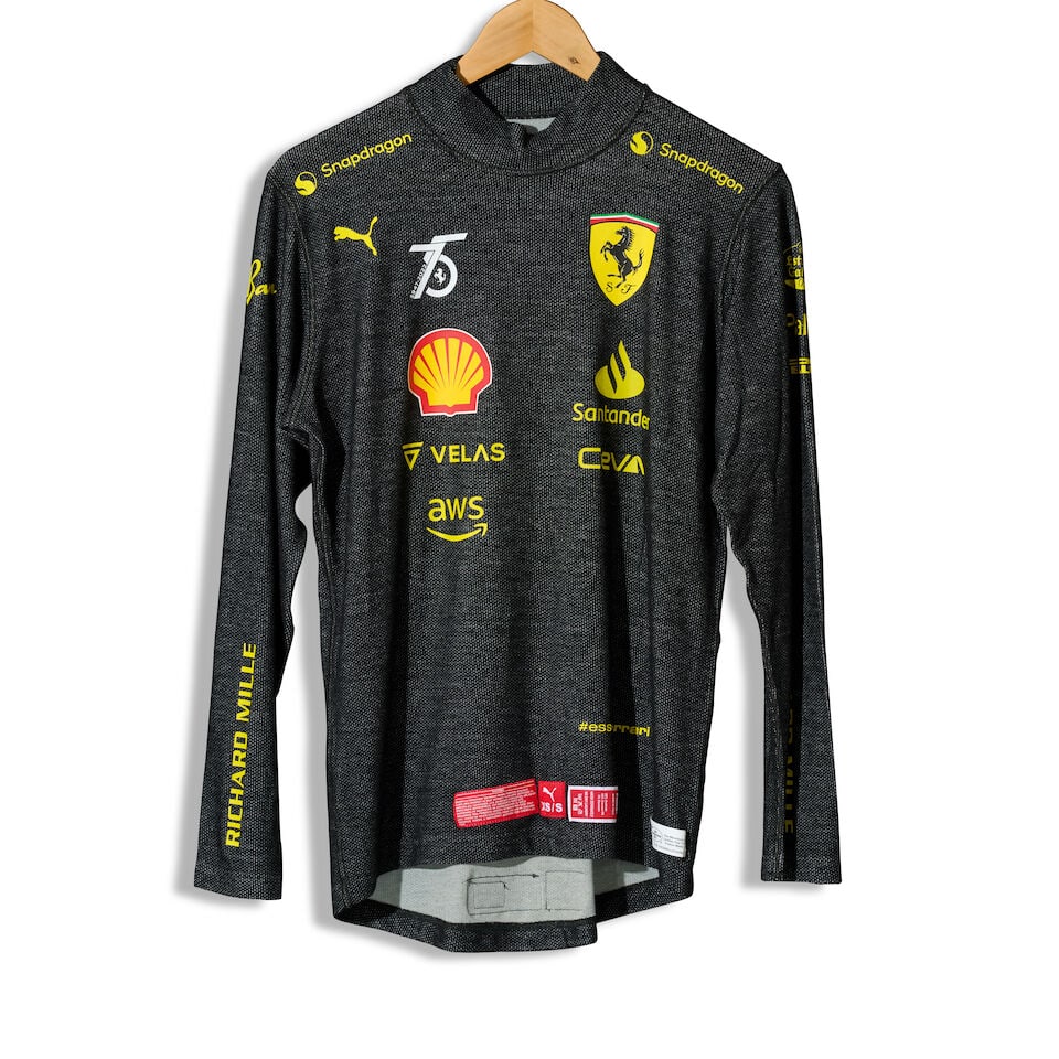 A Charles Leclerc Monza Grand Prix 2022 weekend used Nomex, ((3)): A Charles Leclerc Monza Grand Prix 2022 weekend used Nomex, in black with sponsors logos, signed to the number on the reverse in black by Leclerc, specifications to lower front and back, offered with