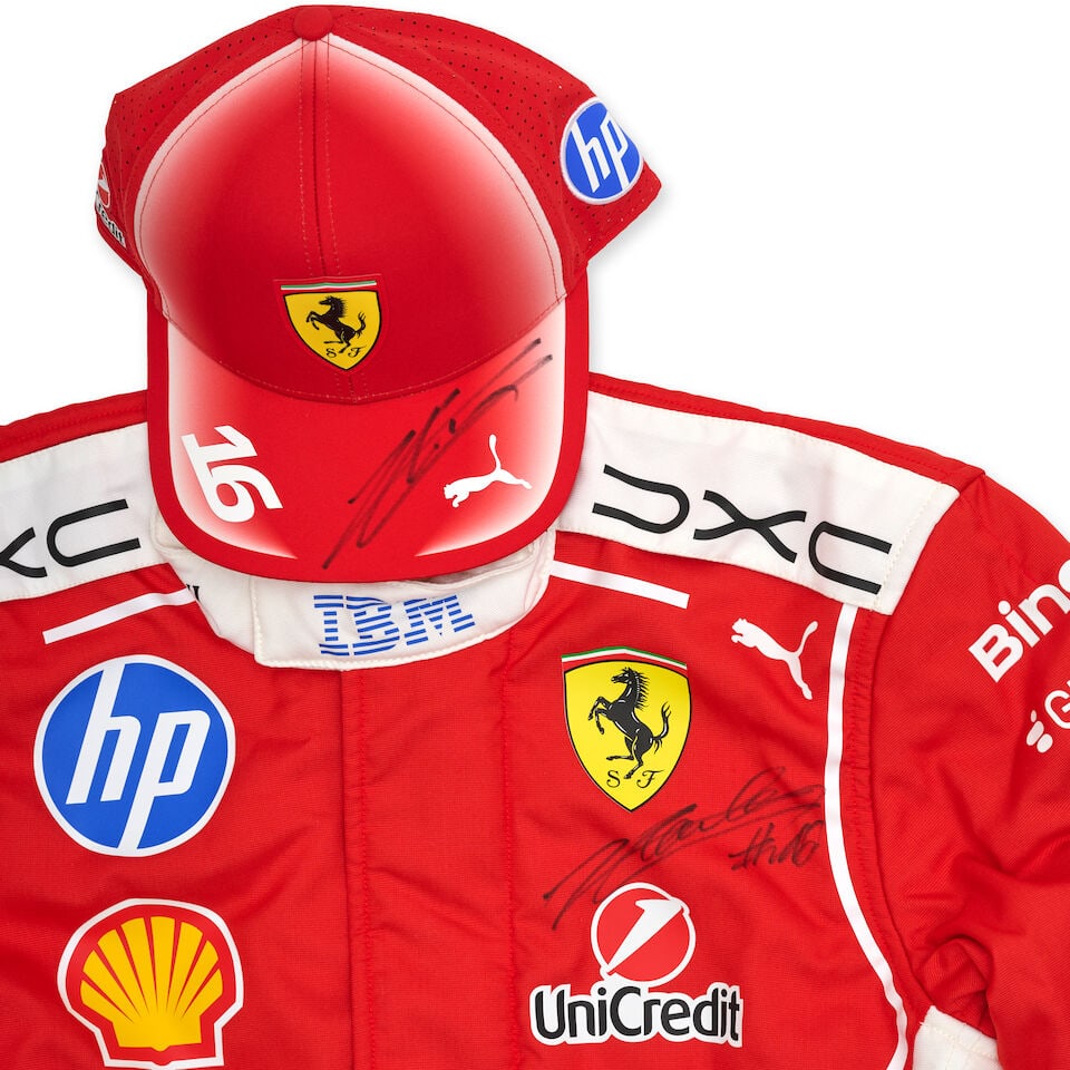 A pair of unused Charles Leclerc Scuderia Ferrari overalls, signed,: A pair of unused Charles Leclerc Scuderia Ferrari overalls, signed, signed below the Ferrari badge in black marker, overalls in red and white with sponsors logos, in original Puma Motorsport bag,