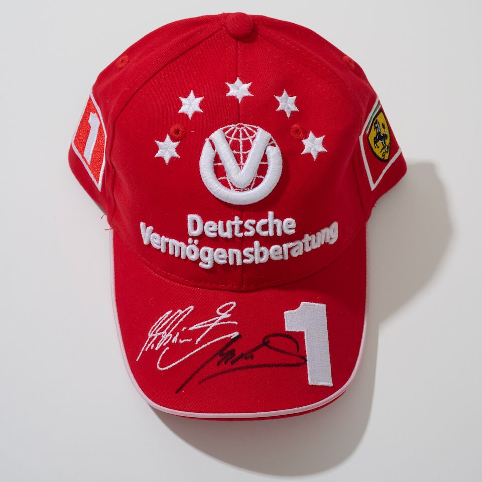 A Scuderia Ferrari Michael Schumacher 2003 cap signed by Mick Schumacher,: A Scuderia Ferrari Michael Schumacher 2003 cap signed by Mick Schumacher, believed size junior, with sponsors logos, signed to the peak in black marker by Mick Schumacher. For further information on