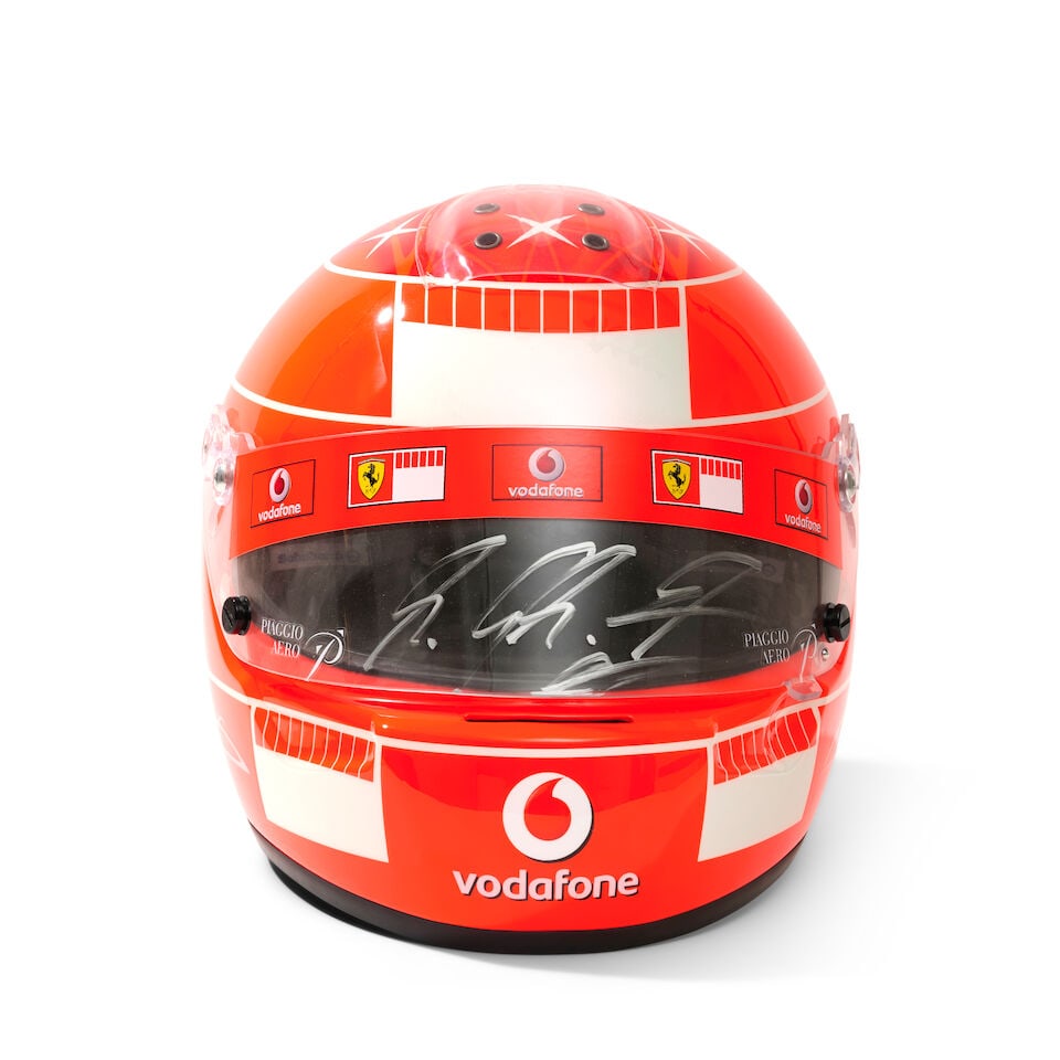 A Michael Schumacher Ferrari F1 2007 'mechanics' helmet, specially commissioned by Schumacher fo...: A Michael Schumacher Ferrari F1 2007 'mechanics' helmet, specially commissioned by Schumacher for the team, commissioned in a limited number of 50 for team members, in red, with Schumacher design,