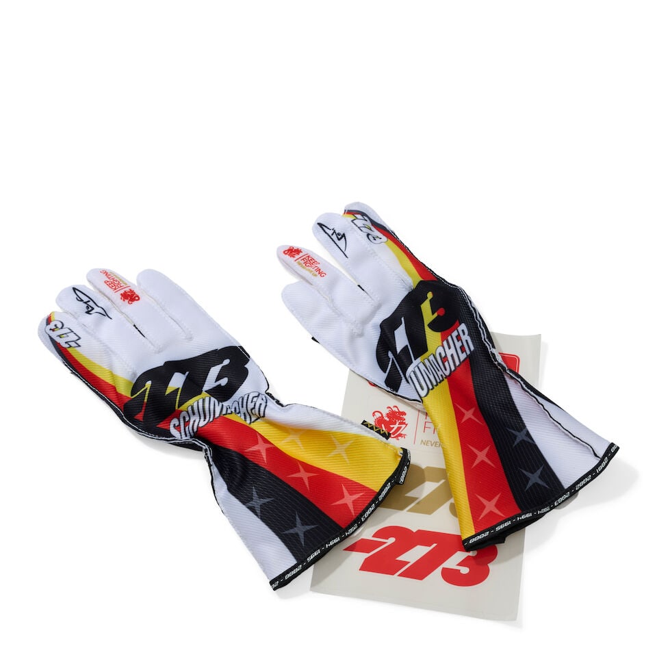 A Pair of Michael Schumacher x 273 Icons Limited edition racing gloves, signed by Mick Schumacher,: A Pair of Michael Schumacher x 273 Icons Limited edition racing gloves, signed by Mick Schumacher, limited edition, signed by Mick Schumacher to the case in silver marker, size M, numbered 002/470.