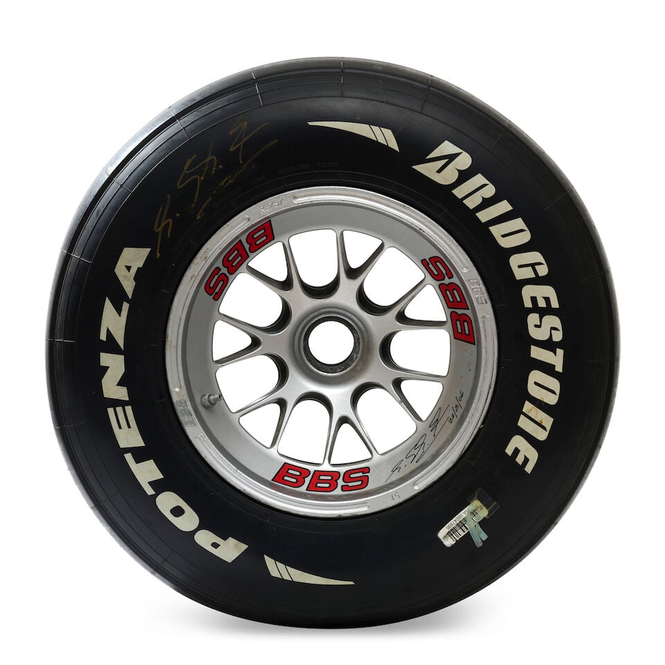 A used Ferrari Formula 1 wheel signed by Michael Schumacher, by BBS,: A used Ferrari Formula 1 wheel signed by Michael Schumacher, by BBS, comprising an unused grooved Bridgestone Potenza tyre, on a used BBS rim, signed in black marker by Michael Schumacher on the rim
