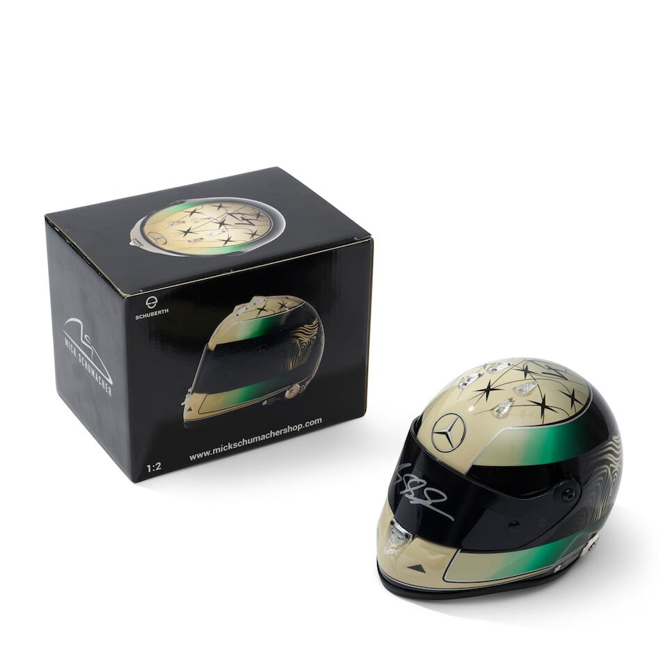 An official signed Mick Schumacher Mercedes 2024 1/2 scale helmet,: An official signed Mick Schumacher Mercedes 2024 1/2 scale helmet, signed to the visor in silver, with original box. For further information on this lot please visit Bonhams.com For further