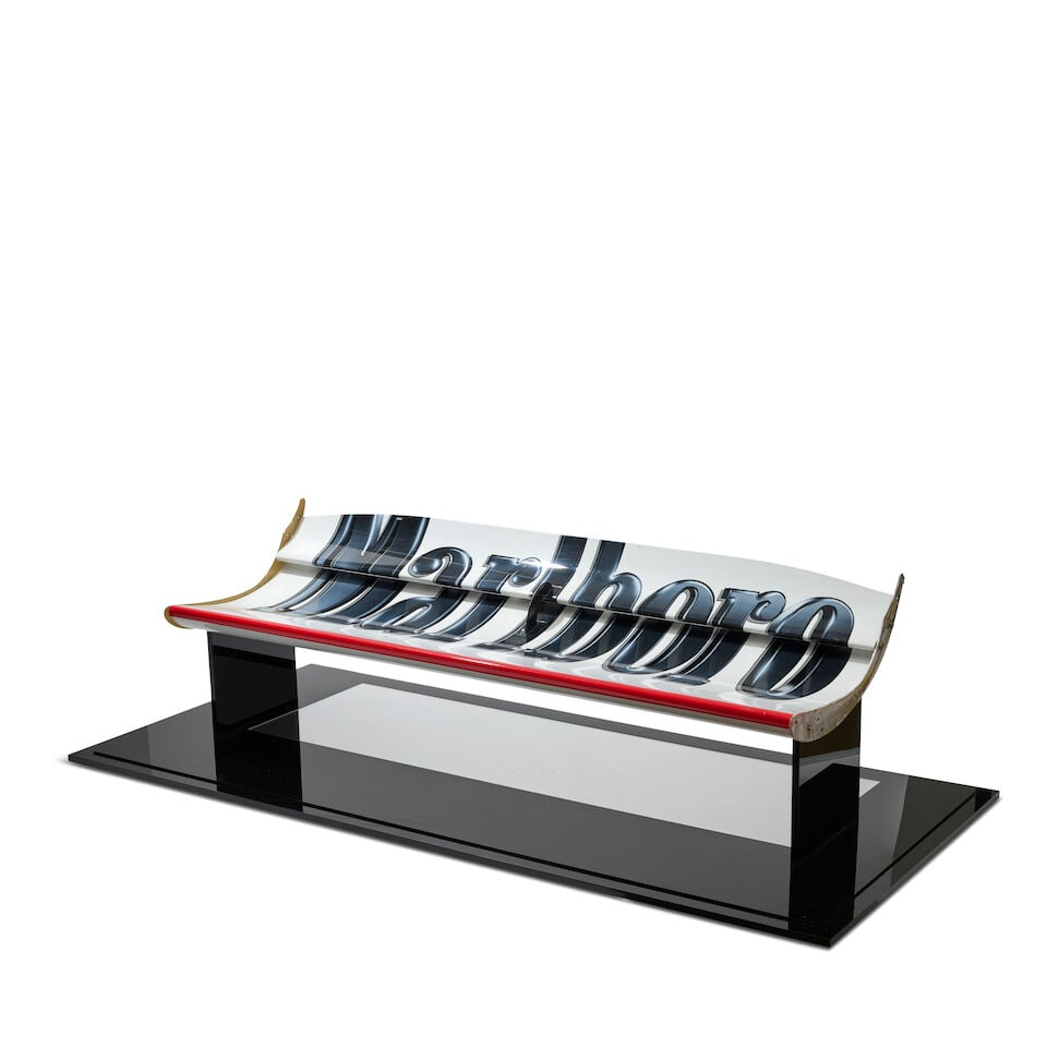 A Scuderia Ferrari F2004 'Marlboro' rear wing, believed from Michael Schumacher's car,: A Scuderia Ferrari F2004 'Marlboro' rear wing, believed from Michael Schumacher's car, carbon fibre construction, in red and white, with Marlboro sponsorship, mounted on a base with mirror, rear wing