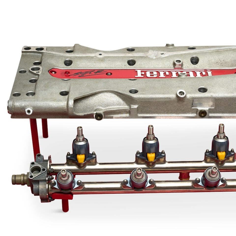 A Ferrari valve cover coffee table, signed by Michael Schumacher, - 2