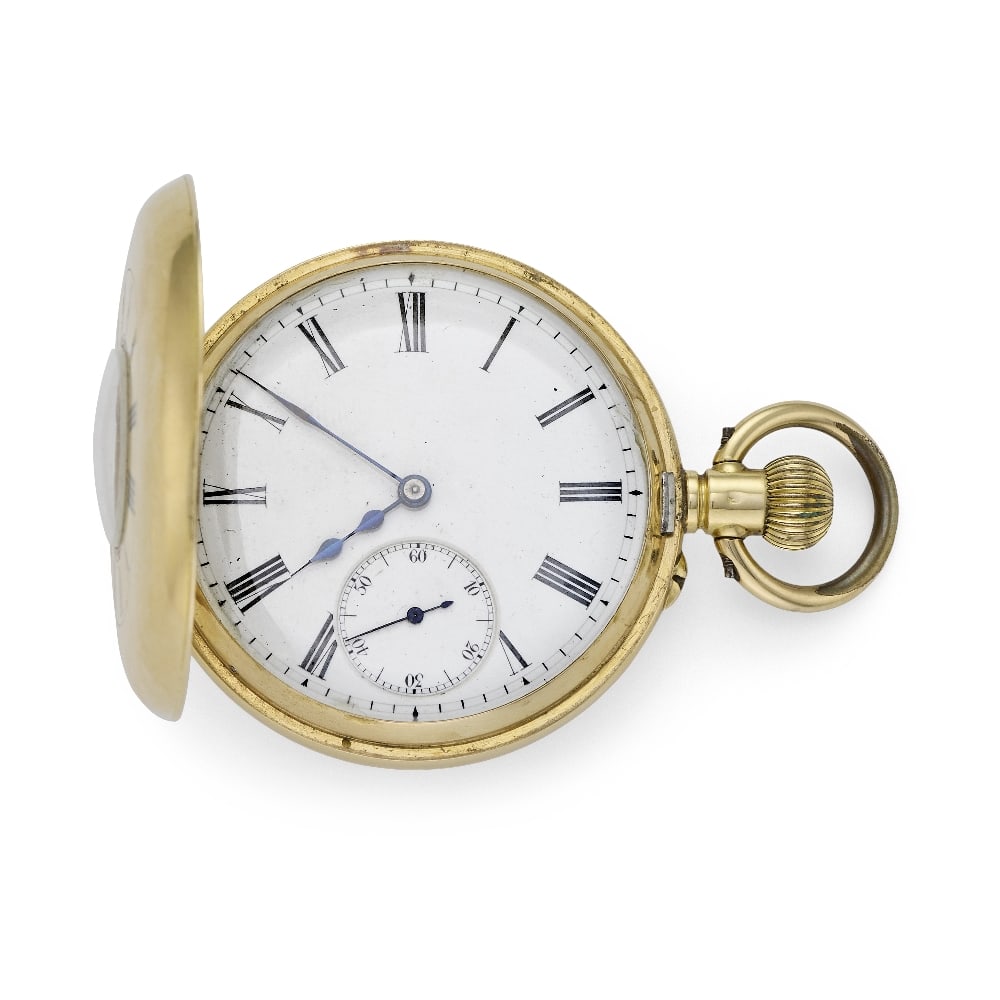An 18K gold keyless wind half hunter pocket watch Circa 1900: An 18K gold keyless wind half hunter pocket watch Date: Circa 1900 Movement: Swiss lever, cut and compensated bi-metallic balance Dial: White, black Roman numeral hour markers, black outer minute trac