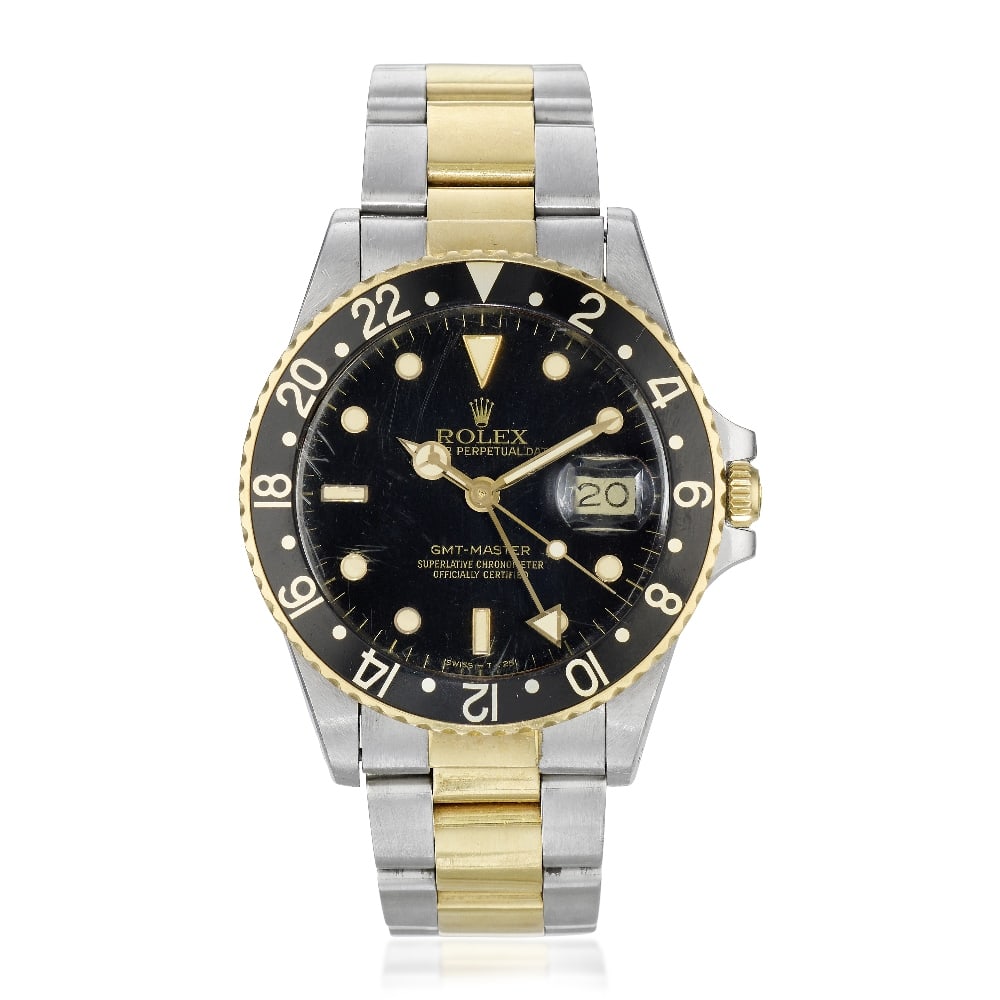 Rolex. A stainless steel and gold automatic calendar bracelet watch with dual time zone GMT-Mas...: Rolex. A stainless steel and gold automatic calendar bracelet watch with dual time zone Model: GMT-Master Reference: 16753 Date: Circa 1987 Movement: 27-jewel Cal.3075 automatic, No.1089287 Dial: Blac