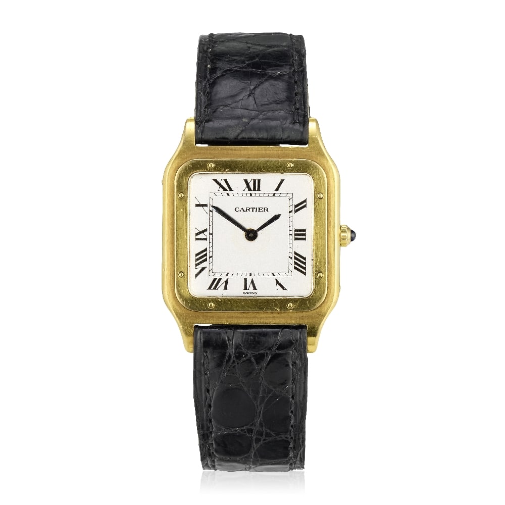 Cartier. An 18K gold manual wind wristwatch Santos Dumont, Circa 1980: Cartier. An 18K gold manual wind wristwatch Model: Santos Dumont Date: Circa 1980 Movement: 17-jewel Cal.21 manual wind, No.8346 Dial: White, black Roman numeral hour markers, black inner minute track