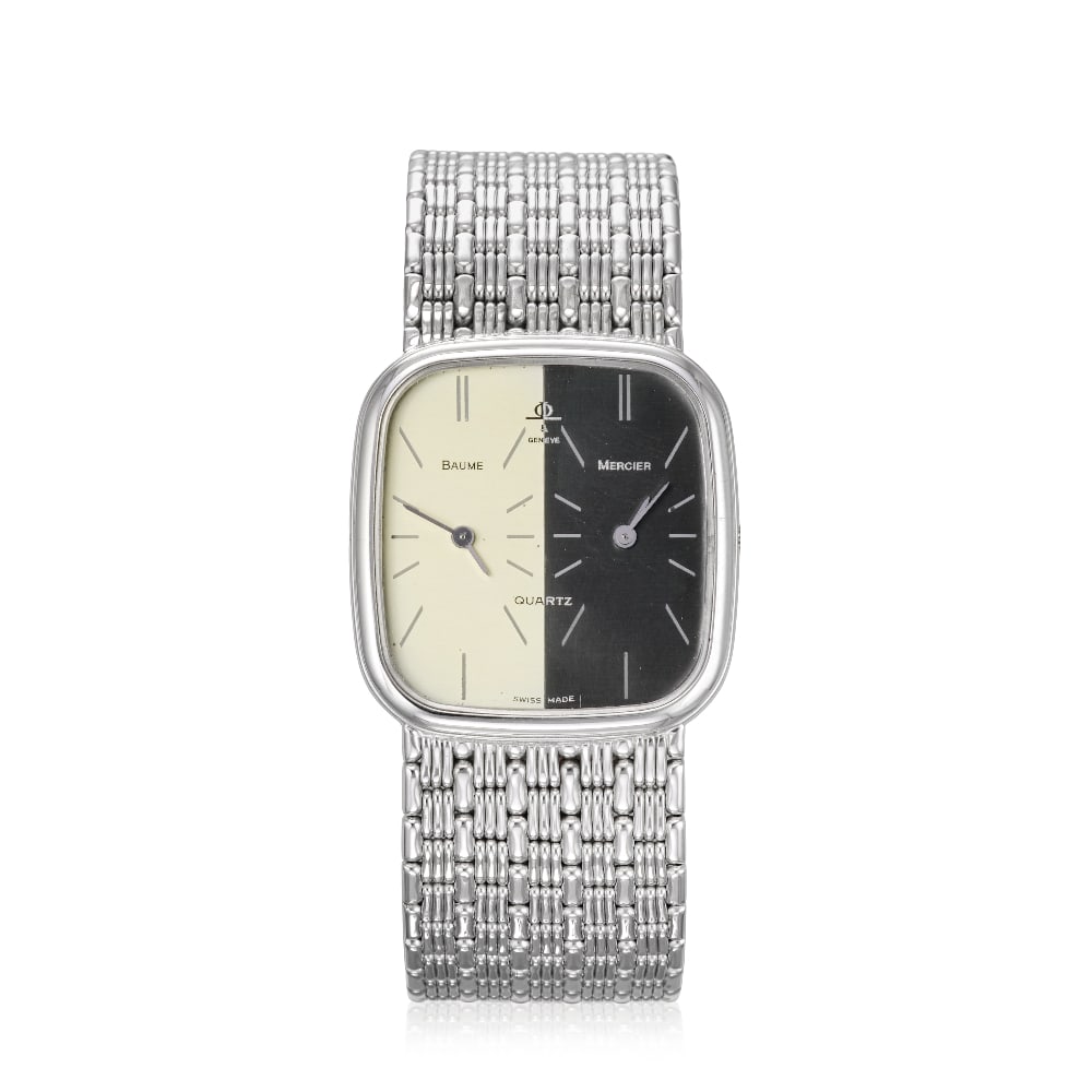 Baume & Mercier. An 18K white gold quartz dual time bracelet watch Ref: 42005, Circa 1980: Baume & Mercier. An 18K white gold quartz dual time bracelet watch Reference: 42005 Date: Circa 1980 Movement: Dual 3-jewel Cal.BM5000 quartz Dial: Black and silvered, applied polished baton hour mark