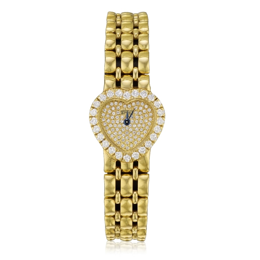 Piaget. A lady's 18K gold diamond set quartz bracelet watch Classique Heart, Ref: 8446 K 61, Ci...: Piaget. A lady's 18K gold diamond set quartz bracelet watch Model: Classique Heart Reference: 8446 K 61 Date: Circa 1990 Movement: 10-jewel Cal.8P2 quartz, No.151343 Dial: Diamond set, blued steel lea
