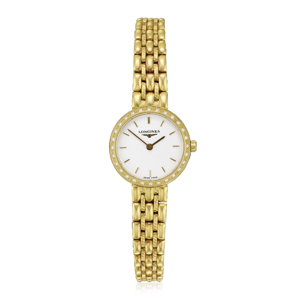 Longines. A lady's 18K gold diamond set quartz bracelet watch Ref: L7 370 7, Circa 2000: Longines. A lady's 18K gold diamond set quartz bracelet watch Reference: L7 370 7 Date: Circa 2000 Movement: 5-jewel ETA quartz Dial: White, applied gilt baton hour markers, gilt pointed baton hands C