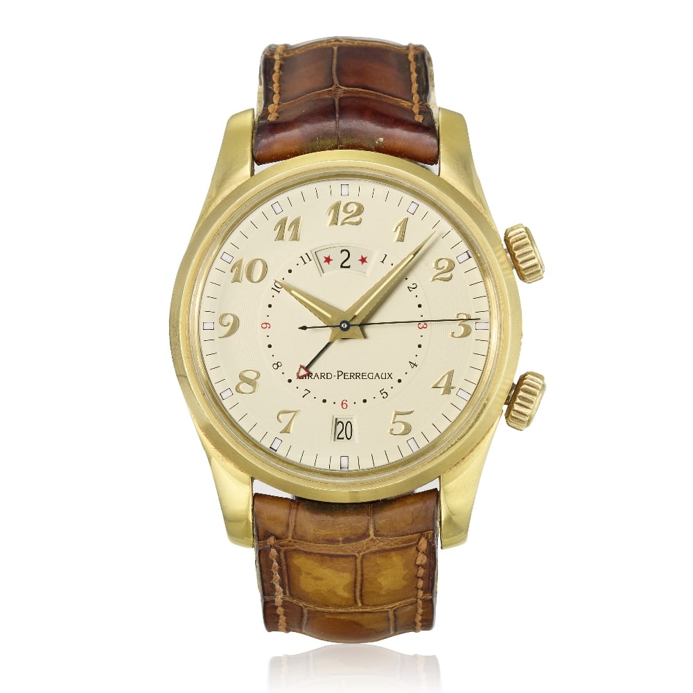 Girard-Perregaux. An 18K gold automatic calendar wristwatch with alarm and dual time zone Trave...: Girard-Perregaux. An 18K gold automatic calendar wristwatch with alarm and dual time zone Model: Traveller II Reference: 4935 Date: Purchased 3rd February 2013 Movement: 31-jewel Cal.2291 automatic Di