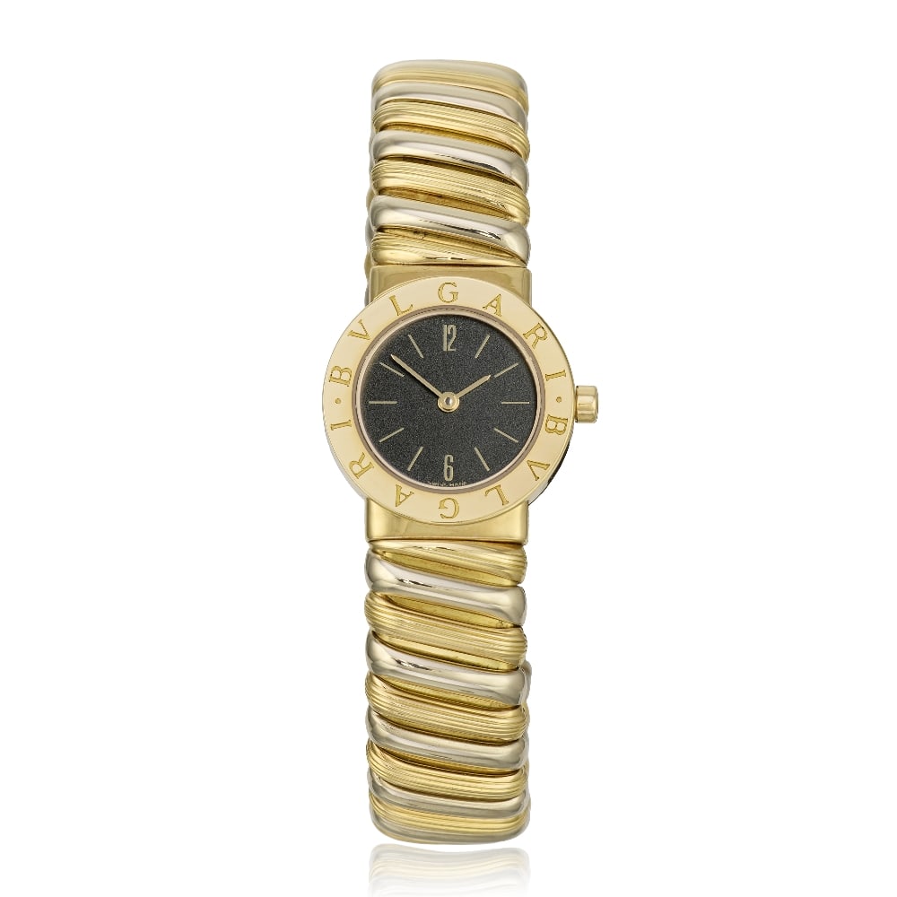Bulgari. A lady's two colour 18K gold quartz bangle watch Ref: BB 23 2T, Circa 2000: Bulgari. A lady's two colour 18K gold quartz bangle watch Reference: BB 23 2T Date: Circa 2000 Movement: 8-jewel Cal.712-93 quartz Dial: Black, applied gilt baton hour markers, gilt pointed baton hand