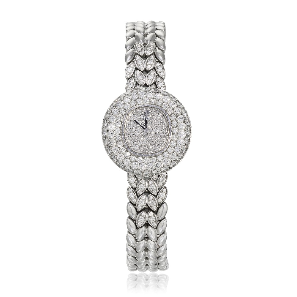 Audemars Piguet. A lady's 18K white gold diamond set quartz bracelet watch Circa 2000: Audemars Piguet. A lady's 18K white gold diamond set quartz bracelet watch Date: Circa 2000 Movement: 3-jewel Cal.2601 quartz, No.430861 Dial: Diamond set, black pointed baton hands Case: Brushed and 