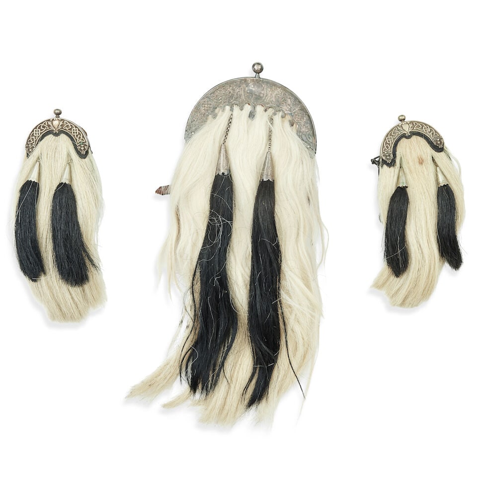 A white-metal mounted sporran: A white-metal mounted sporran Early 20th century The arched cantle engraved with knotwork and zoomorphic designs, centred on a circular cartouche, and surmounted by a knob, the bag faced in horsehair