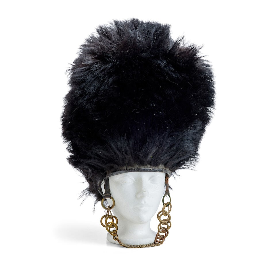 A Military bearskin busby or cap: A Military bearskin busby or cap Late 19th century With internal wicker support, leather sweatband, and brass chin-chain, the interior with maker's paper label of 'Edward Smith from Garter, Pall