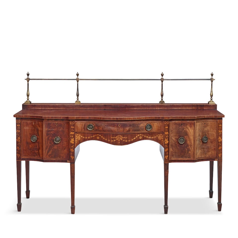 A Scottish George III mahogany and marquetry stage back sideboard Third quarter 18th century: A Scottish George III mahogany and marquetry stage back sideboard Third quarter 18th century With a brass gallery above a serpentine shaped top with a central frieze drawer flanked by four deep