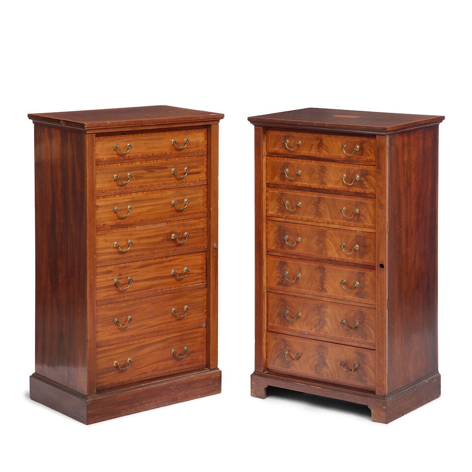 A pair of Edwardian mahogany, satinwood banded and boxwood strung Wellington chests Late 19th / ...: A pair of Edwardian mahogany, satinwood banded and boxwood strung Wellington chests Late 19th / early 20th century in the George III style Each with locking baton and seven drawers on a plinth base,