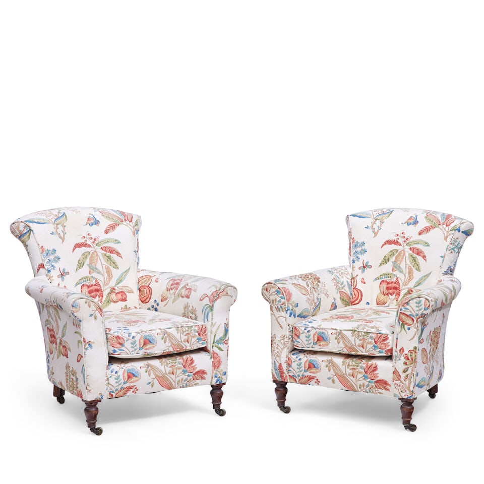 A pair of Victorian upholstered easy armchairs Second half 19th century (2): A pair of Victorian upholstered easy armchairs Second half 19th century On turned mahogany front legs and canted back legs with brass castors, 81cm wide x 80cm deep x 85cm high, (31 1/2in wide x 31in 