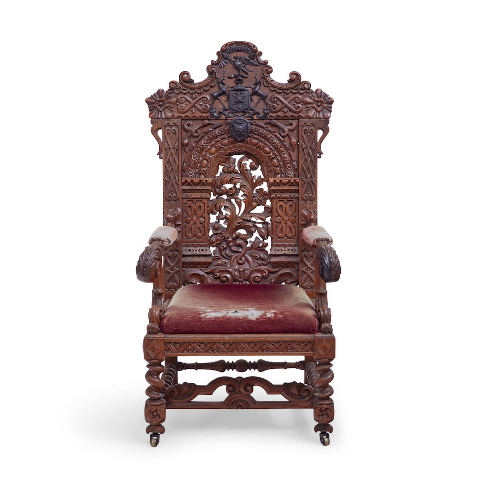 A Victorian carved oak wainscot armchair Third quarter 19th century, in the 17th century style: A Victorian carved oak wainscot armchair Third quarter 19th century, in the 17th century style The profusely carved and pierced back centred by the Maxwell coat of arms flanked by stags with eagle and