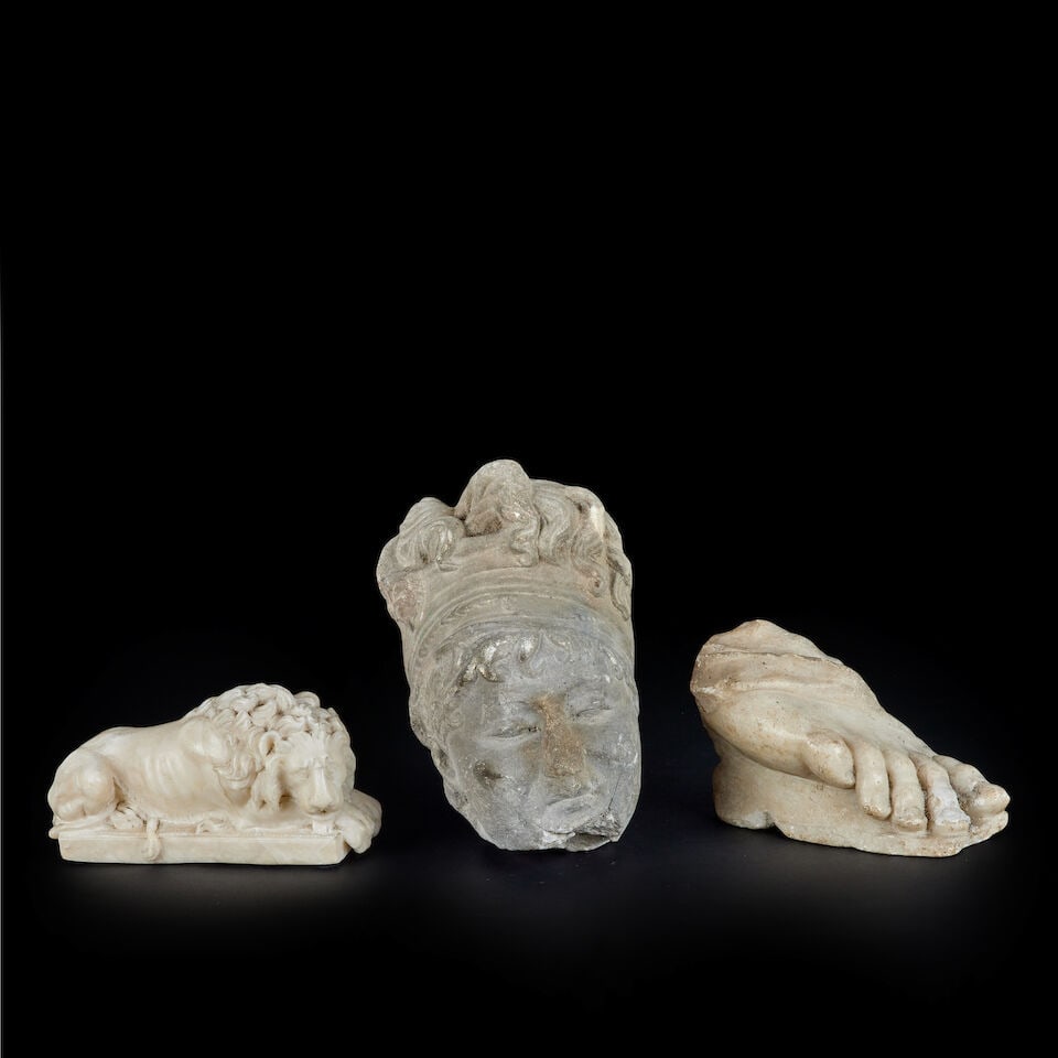 An alabaster model of the 'Chatsworth' Lion After Antonio Canova (Italian, 1757-1822): An alabaster model of the 'Chatsworth' Lion After Antonio Canova (Italian, 1757-1822) 21cm long; together with an 18th / early 19th century carved marble fragment of a foot, 18cm long, and a