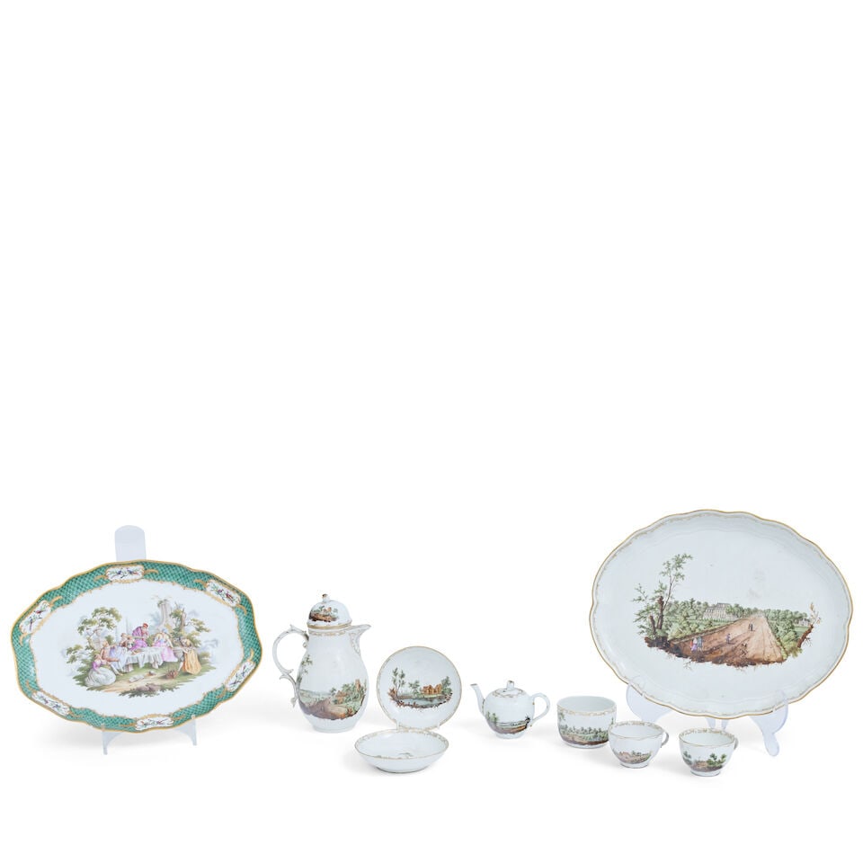 A Furstenberg cabinet service: A Furstenberg cabinet service With titled rural scenes and gilt rims, comprising an oval tray, coffee pot, miniature teapot, two cups and saucers, sucrier (lid lacking), painted marks, the tray 37cm