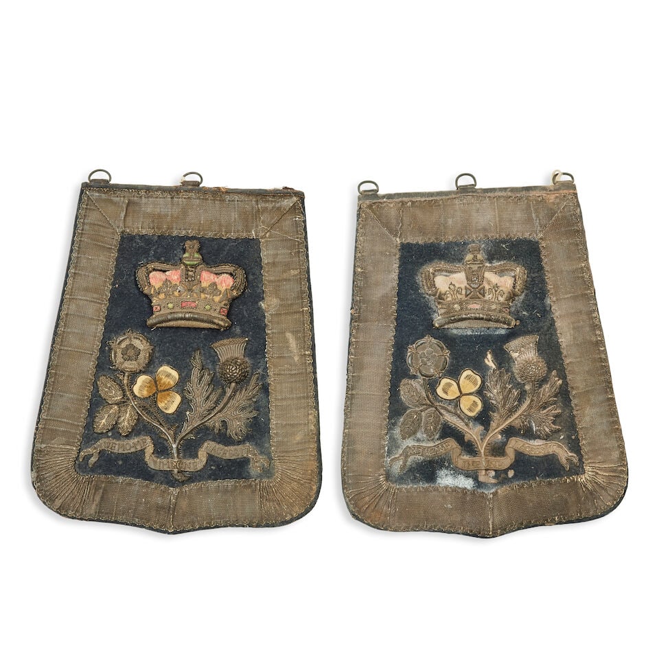 Two William IV Yeomanry Officer's sabretaches: Two William IV Yeomanry Officer's sabretaches Circa 1830-37 Each of red Morocco leather faced in blue cloth with silver train lace border, and embroidered in bullion with crowned union foliage above t