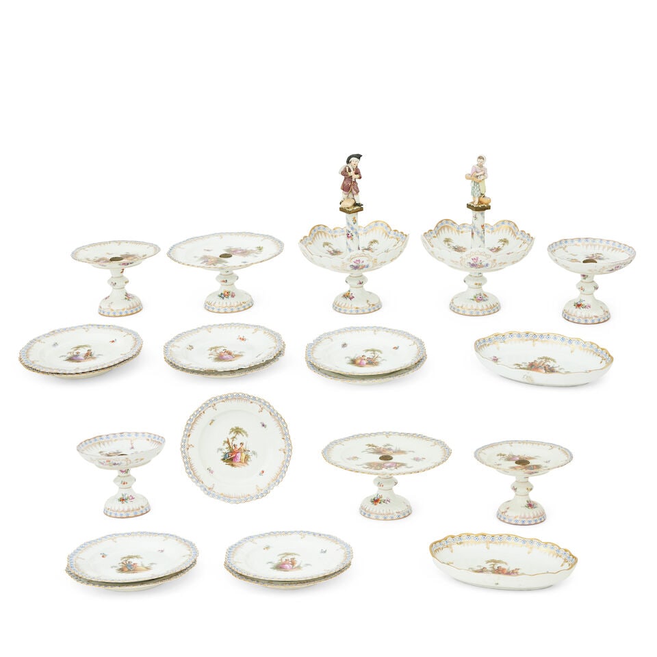 A 19th century Berlin dessert service 19th century: A 19th century Berlin dessert service 19th century With pierced shaped rims, painted with lovers under trees with gilt and May blossom, comprising a pair of shaped dishes on spiral fluted stems with