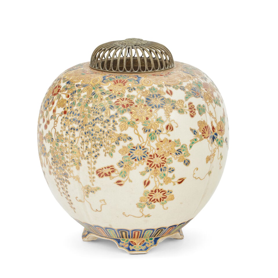 A Satsuma koro Meiji: A Satsuma koro Meiji Decorated with tailing mimosa and other flowers, on four feet, with pierced white metal cover, Satsuma Kaki to base, 18cm high. For further information on this lot please visit Bo