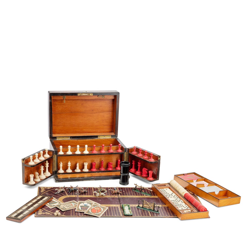 A George IV coromandel wood games compendium Early 19th century: A George IV coromandel wood games compendium Early 19th century The hinged lid and hinged and divided front concealing an interior fitted with a bone Staunton type chess set, fifteen natural and fifte