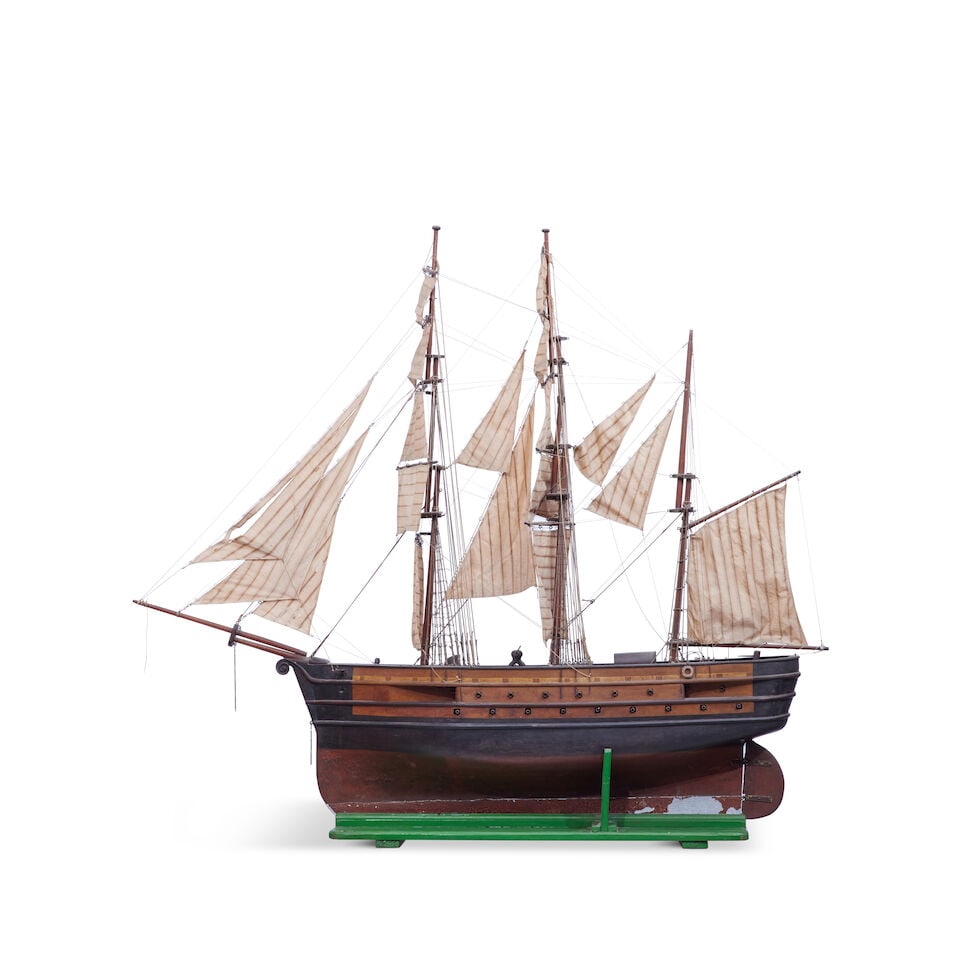 A large scratch built carved and stained wood model of a late 18th century three-masted 34-gun s...: A large scratch built carved and stained wood model of a late 18th century three-masted 34-gun ship Early 20th century Having scroll bow, two runs of guns to either side, silk sails to detailed