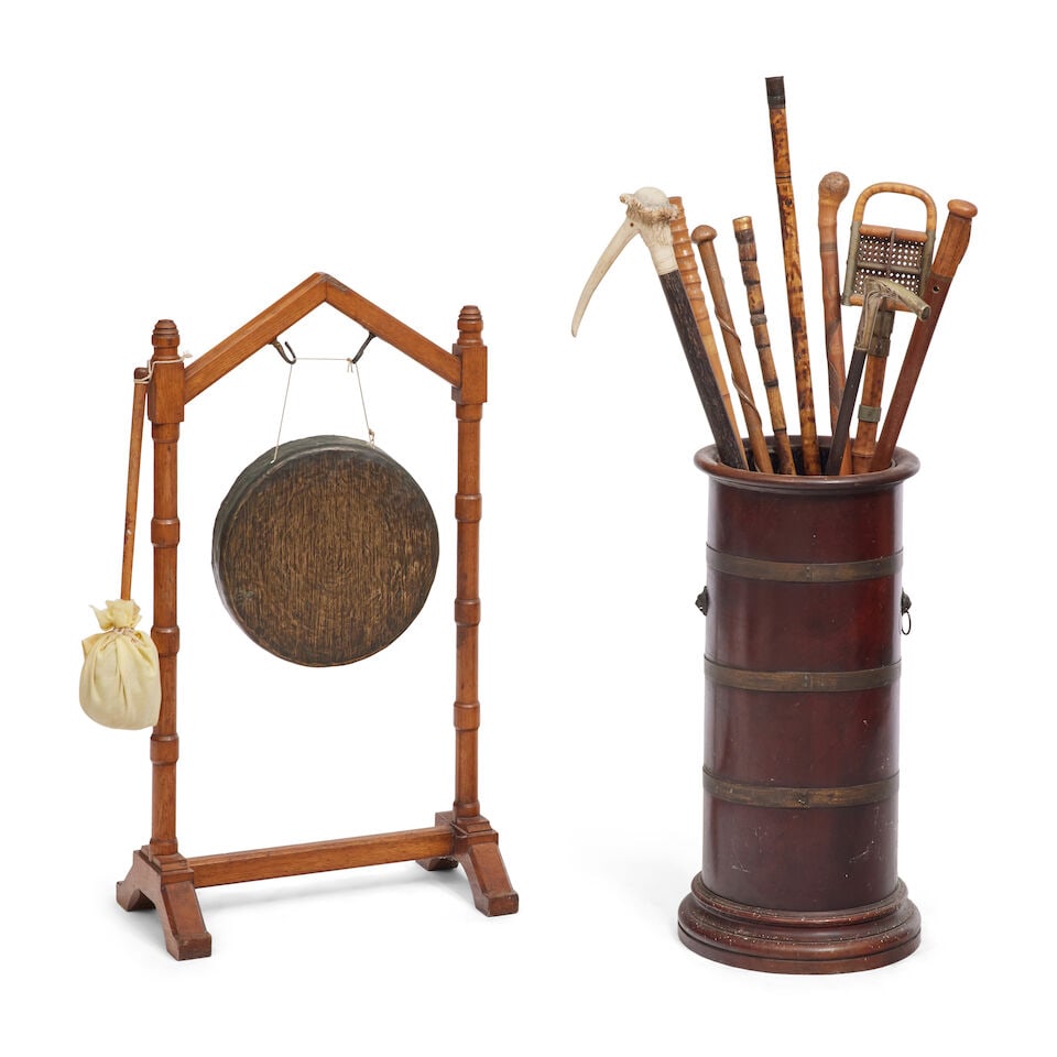 A late Victorian oak and brass dinner gong Late 19th/early 20th century (11): A late Victorian oak and brass dinner gong Late 19th/early 20th century Together with a mahogany and brass bound stick stand, early 20th century, of circular design with a tole liner, and a selection 