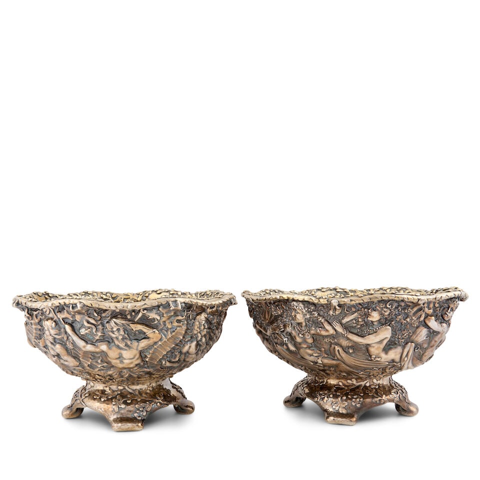 Pair of Tiffany & Co. Sterling Silver Centerbowls,: Pair of Tiffany & Co. Sterling Silver Centerbowls, New York, c. 1885, likely designed by Charles Osborn, marked mermaid: 7338/8934, mermen: 7358/8984; each featuring a chased aquatic motif, one with m
