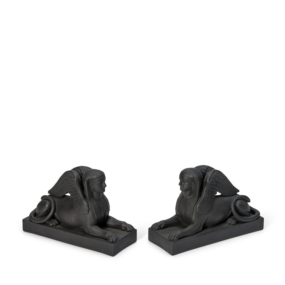 Pair of Wedgwood Black Basalt Models of Seated Sphinx, England, 19th century,: Pair of Wedgwood Black Basalt Models of Seated Sphinx, England, 19th century, each set on a rectangular base, impressed marks, lg. 6 1/2, ht. 4 1/4 in. Footnotes: Provenance Faith and Bruce Lewis Coll
