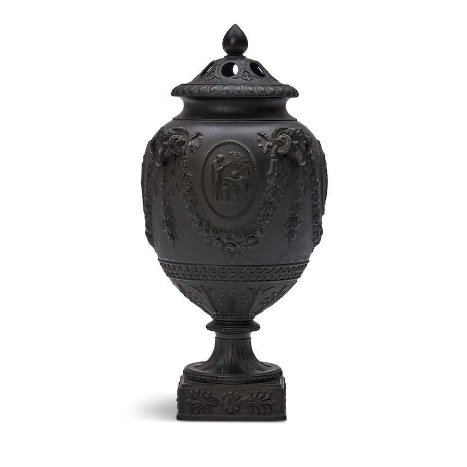 Wedgwood Black Basalt Potpourri Vase and Covers, England, 19th century,: Wedgwood Black Basalt Potpourri Vase and Covers, England, 19th century, pierced cover with an insert disc lid, the bulbous body in relief with classical medallions within floral festoons terminating a