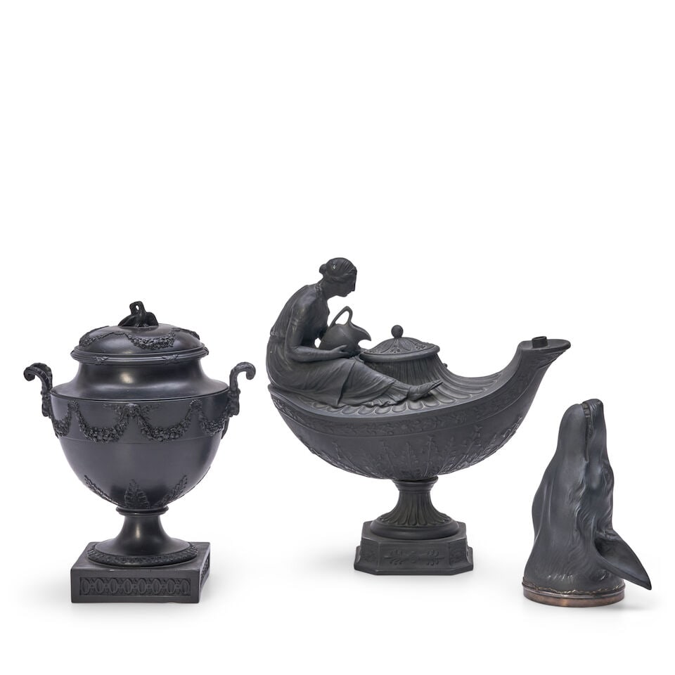 Three Black Basalt Items, England, late 18th and 19th century,: Three Black Basalt Items, England, late 18th and 19th century, an unmarked fox head stirrup cup with silver rim, lg. 5 1/8; with two marked Wedgwood, a vestal oil lamp and cover, ht. 8 3/4; and a cove