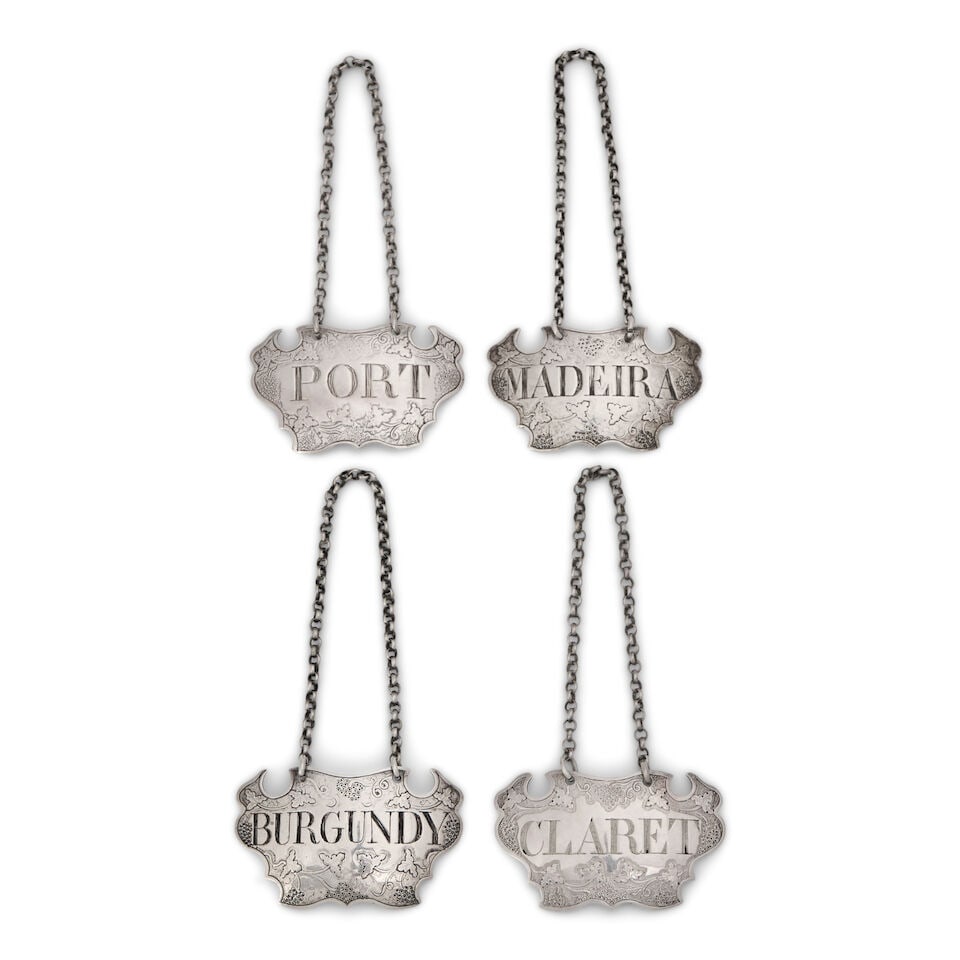 Four Georgian Sterling Silver Bottle Tickets,: Four Georgian Sterling Silver Bottle Tickets, London, mid-18th century, Sandylands Drinkwater, maker, each label shaped and chased with grape and vine motif, approx. 1.60 troy oz. Note: Sandylands Dri