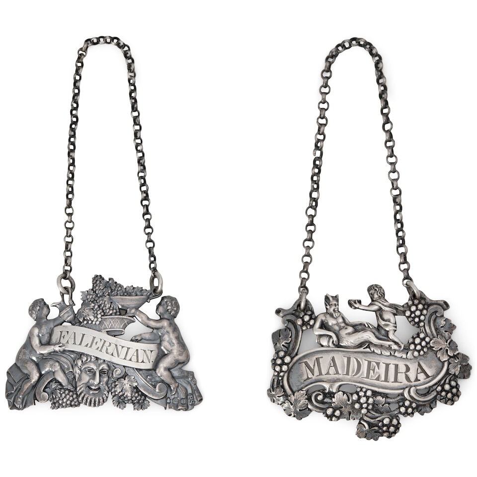 Two Regency Sterling Silver Bottle Tickets,: Two Regency Sterling Silver Bottle Tickets, the Madeira label marked for London, 1812, Thomas Phipps, Edward Robinson & James Phipps, makers; the Falernian label apparently unmarked; featuring two Bac