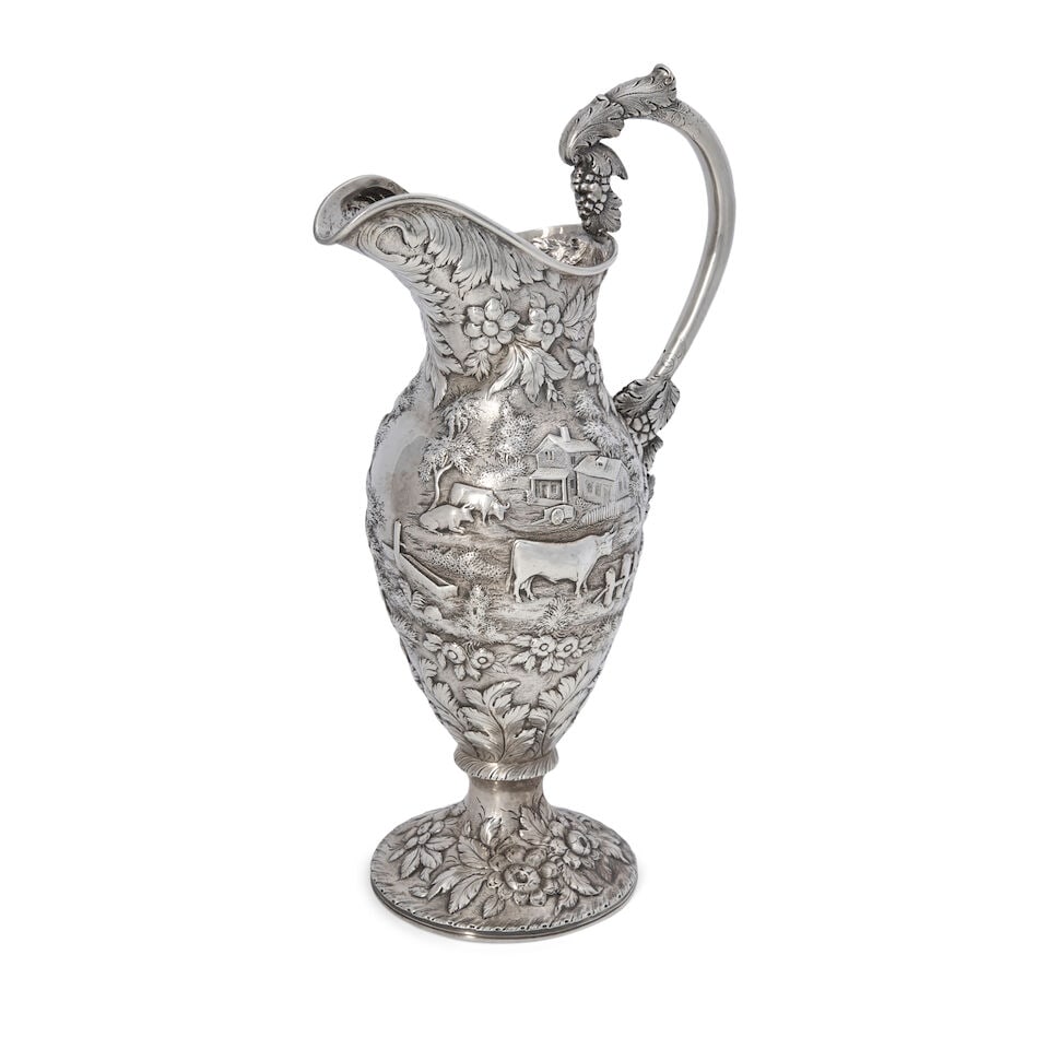 A Large S. Kirk 11oz Silver Ewer,: A Large S. Kirk 11oz Silver Ewer, Baltimore, Maryland, 1846-1861, hand chased with pastoral landscape against a stippled ground, the central cartouche left blank, the cast handle with grape bunches,