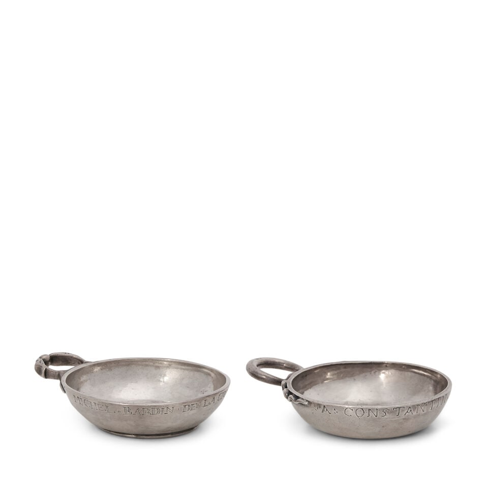 Two French Silver Tastevins,: Two French Silver Tastevins, 18th century, both with rubbed marks, both of standard form, one with snake-form handle, inscribed 'A. Constantin', the other with a double eagle head handle, inscribed