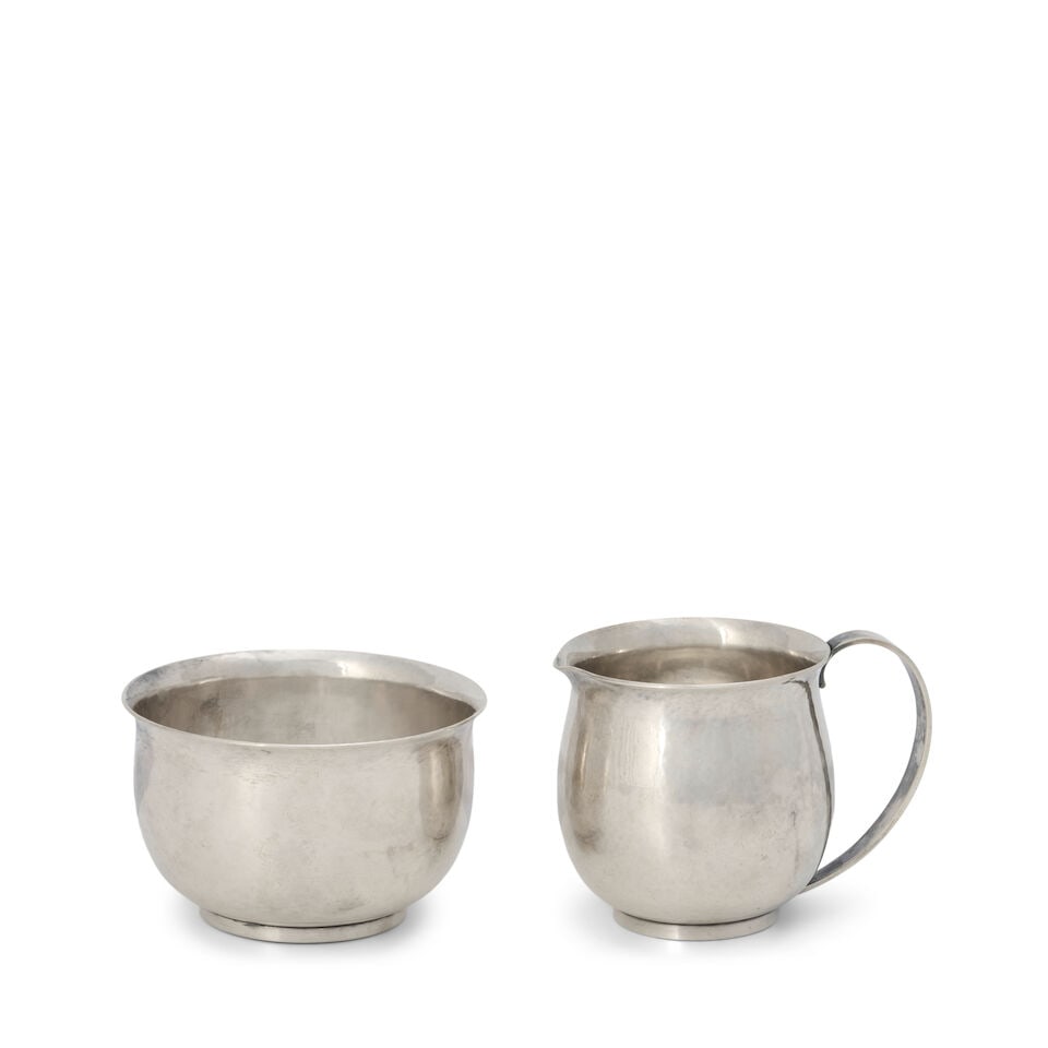 Georg Jensen Sterling Silver Creamer and Sugar '527',: Georg Jensen Sterling Silver Creamer and Sugar '527', Denmark, post-1945, the bulbous, hand-hammered body with a flared lip, the creamer sided by a strap handle, creamer ht. 2 1/2, sugar dia. 3 3/8 in