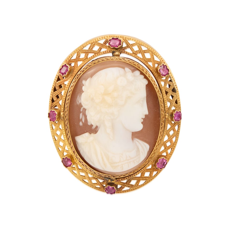 ANTIQUE 18K GOLD AND SHELL CAMEO BROOCH: ANTIQUE 18K GOLD AND SHELL CAMEO BROOCH • 18k yellow gold • 8 rectangular rubies weighing approximately 0.65 - 0.75 carat total • 1 oval shell cameo • Measures 1 5/8 x 1 3/8 in