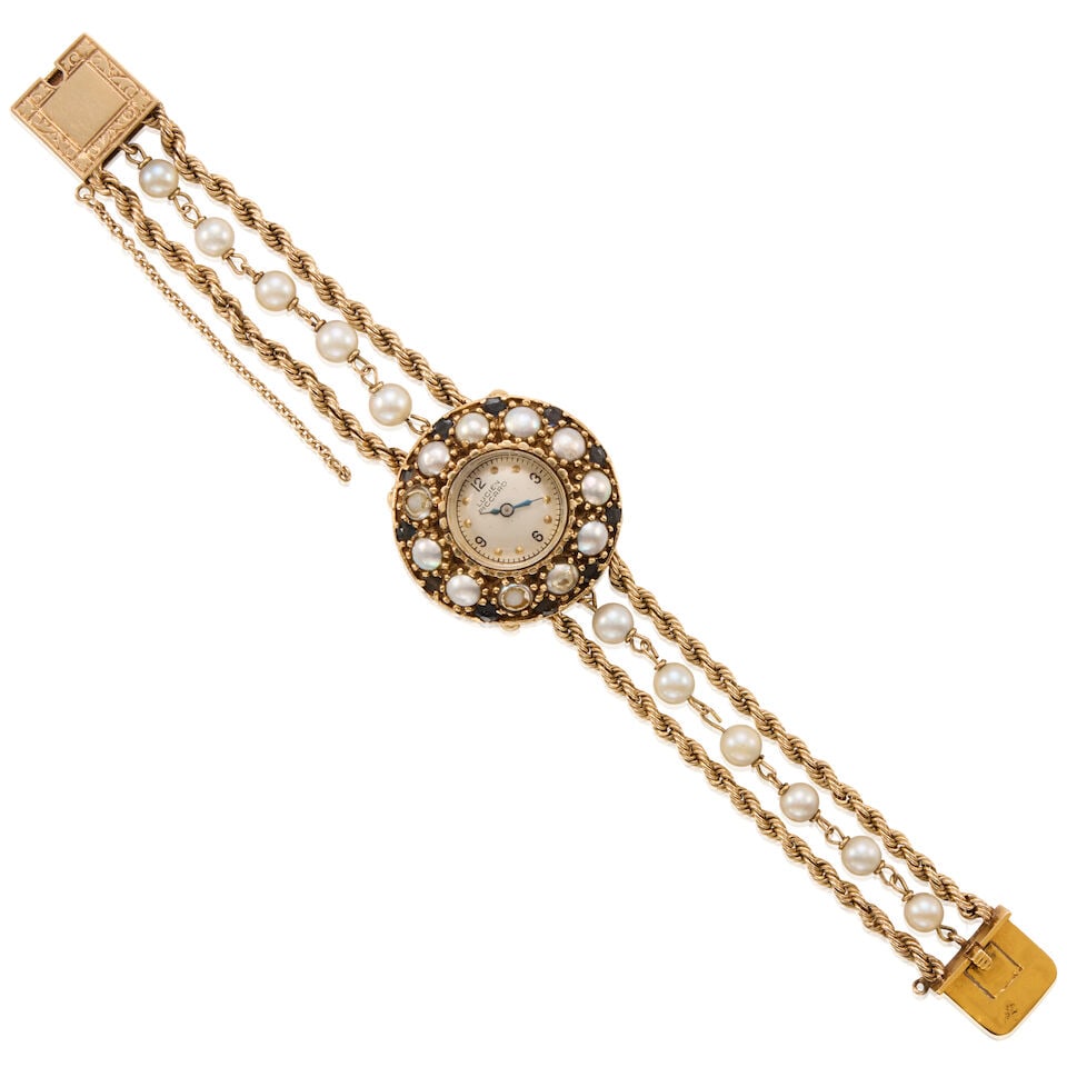 14K GOLD, CULTURED PEARL, AND SAPPHIRE WRISTWATCH: 14K GOLD, CULTURED PEARL, AND SAPPHIRE WRISTWATCH • 14K yellow gold watch case and bracelet • Numerous cultured pearls measuring approximately 5.06mm in diameter • Numerous oval shap