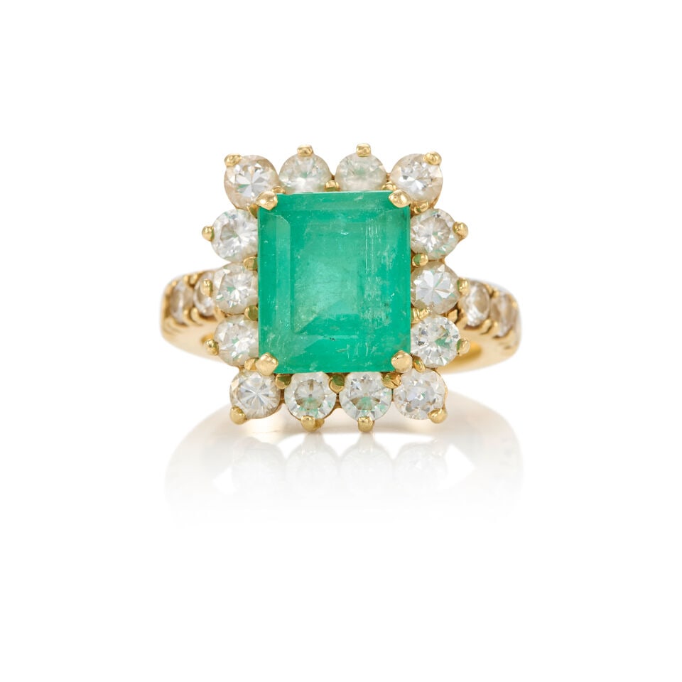 14K GOLD, EMERALD AND DIAMOND RING: 14K GOLD, EMERALD AND DIAMOND RING • 14K yellow gold • One rectangular shaped emerald weighing approximately 4.50 carats • Numerous round shaped diamonds weighing approximately 1.90