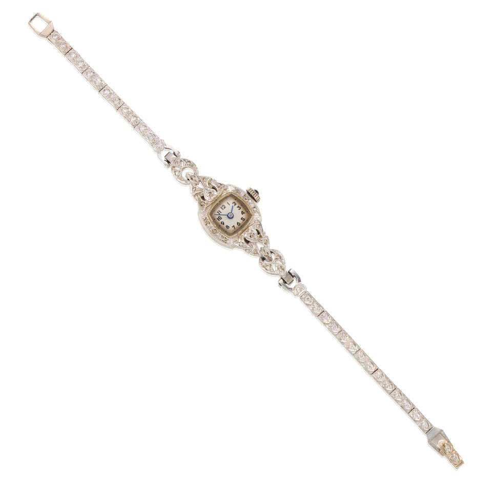 14K GOLD AND DIAMOND WRISTWATCH: 14K GOLD AND DIAMOND WRISTWATCH • 14K white gold watch case and bracelet • Numerous round shaped diamonds weighing approximately 0.50 carat total • One round blue stone on the dial