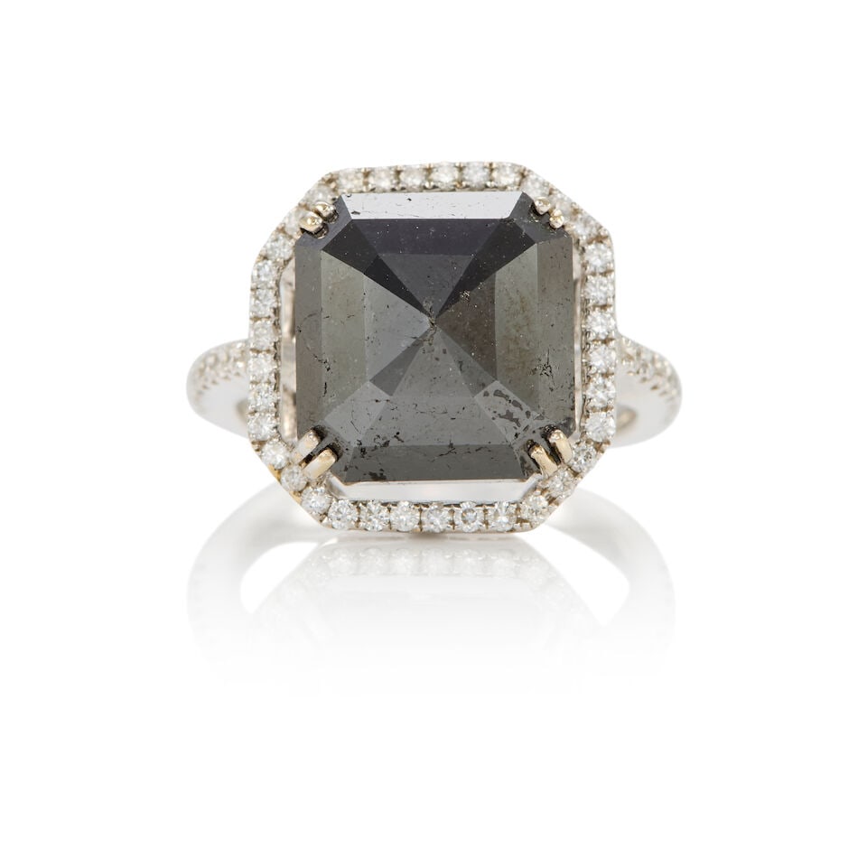 18K GOLD, BLACK DIAMOND, AND DIAMOND RING: 18K GOLD, BLACK DIAMOND, AND DIAMOND RING • 18K white gold • One square shaped black diamond weighing approximately 8.10 carats total • Numerous round shaped diamonds weighing approx