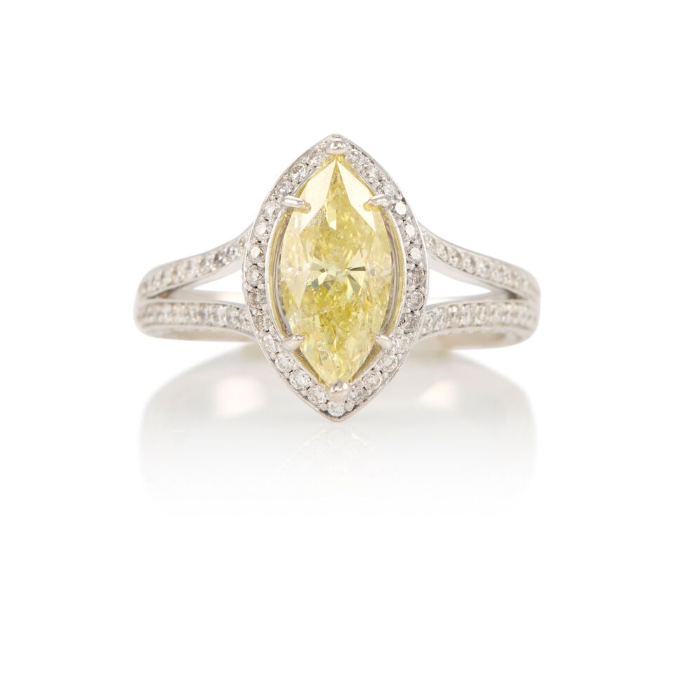 18K GOLD AND FANCY INTENSE YELLOW DIAMOND RING WITH GIA REPORT: 18K GOLD AND FANCY INTENSE YELLOW DIAMOND RING WITH GIA REPORT • 18k white gold • Numerous round diamonds weighing approximately 0.80 - 0.90 carat total • 1 marquise-shaped Fancy