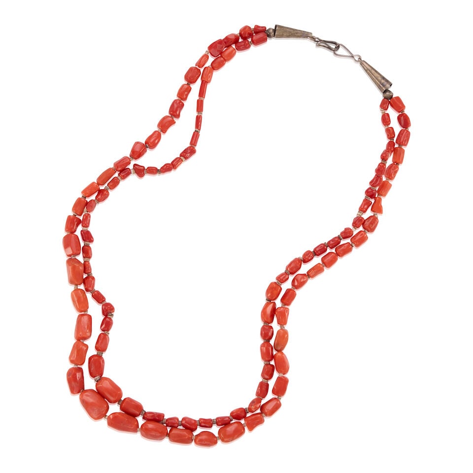 SILVER AND CORAL NECKLACE: SILVER AND CORAL NECKLACE • Silver • 2 strands of graduated coral beads • Length 22 1/4 in. • Estimated gross weight: 55.7 grams Footnotes: Please note this item cannot be